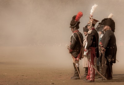 Three man in a black and white suit with red smoke tube
